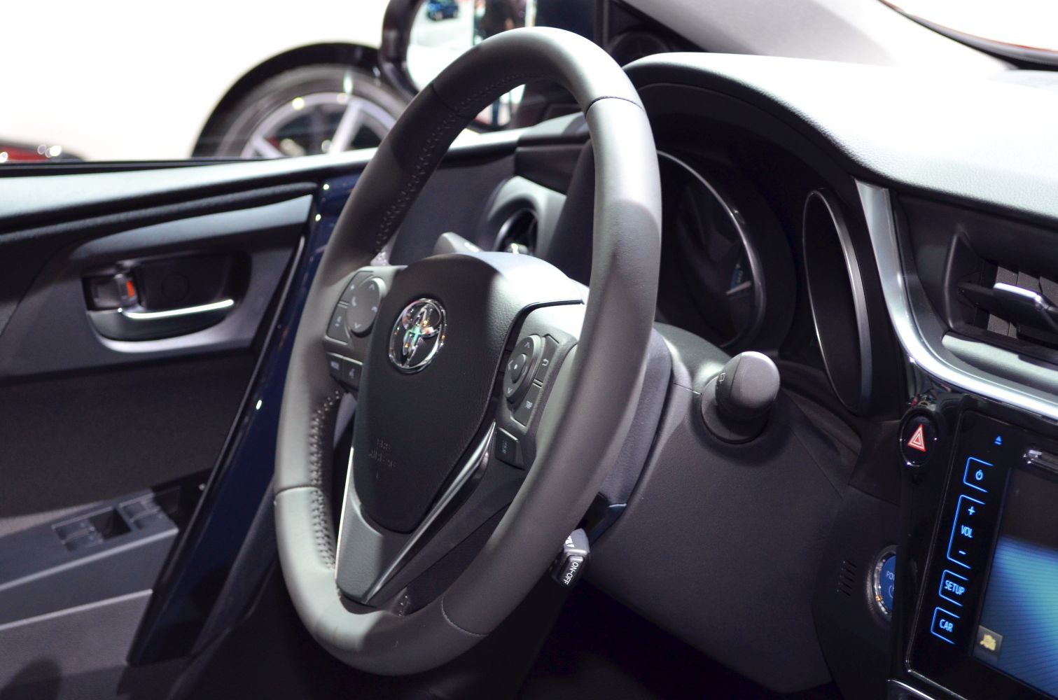 Steering wheel and dashboard controls with infotainment display