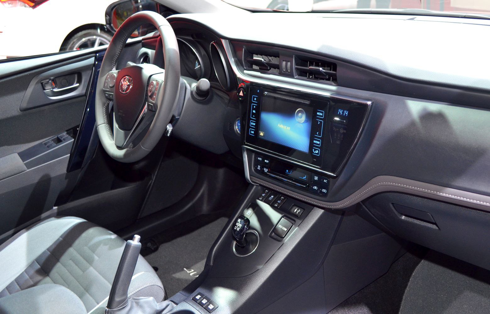 Modern car interior with touchscreen infotainment and ergonomic dashboard.