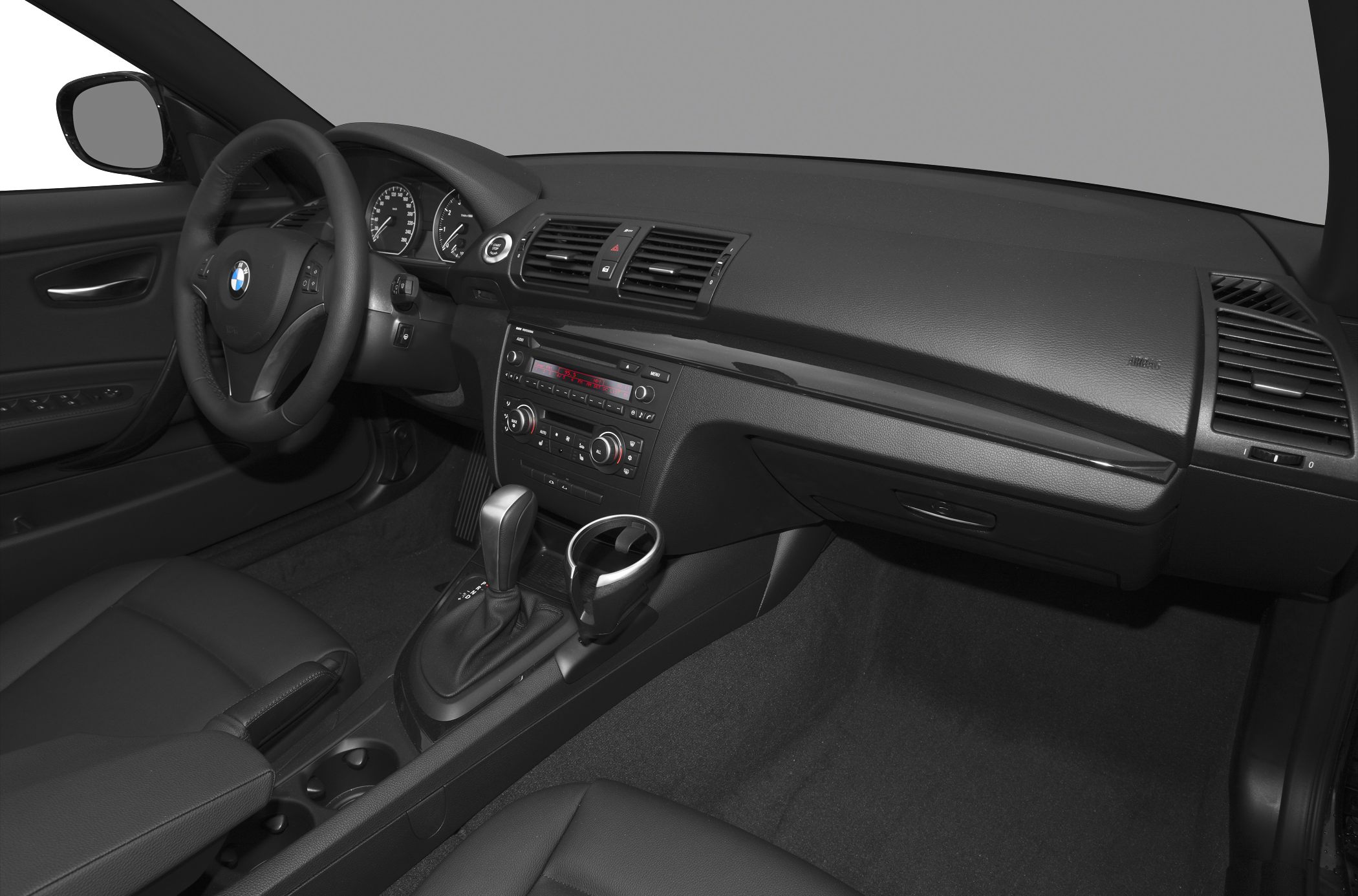Interior view with dashboard, steering wheel, and automatic gear shift