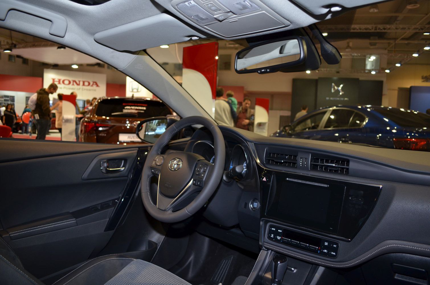 Modern car interior featuring dashboard, steering wheel, and central infotainment screen.