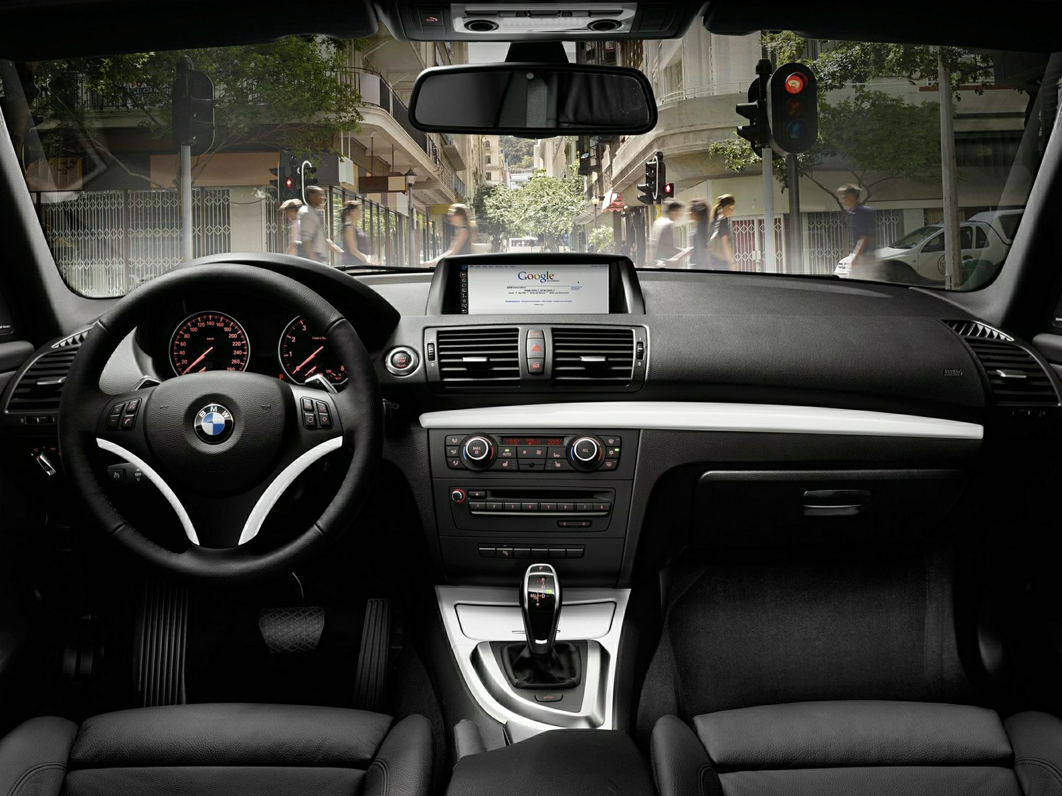 BMW interior dashboard with steering wheel and infotainment screen