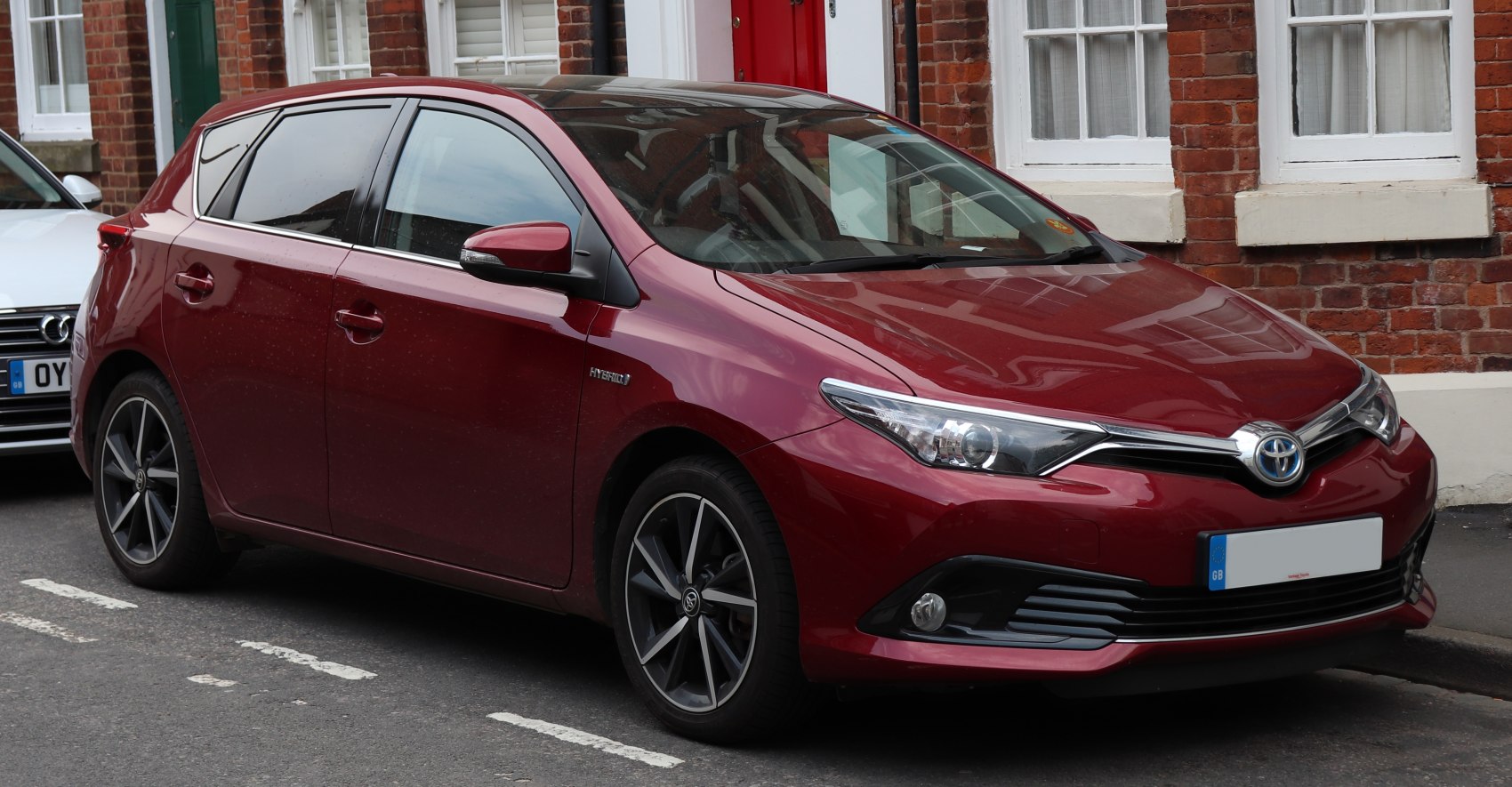 Front side view of hatchback with hybrid badge and alloy wheels