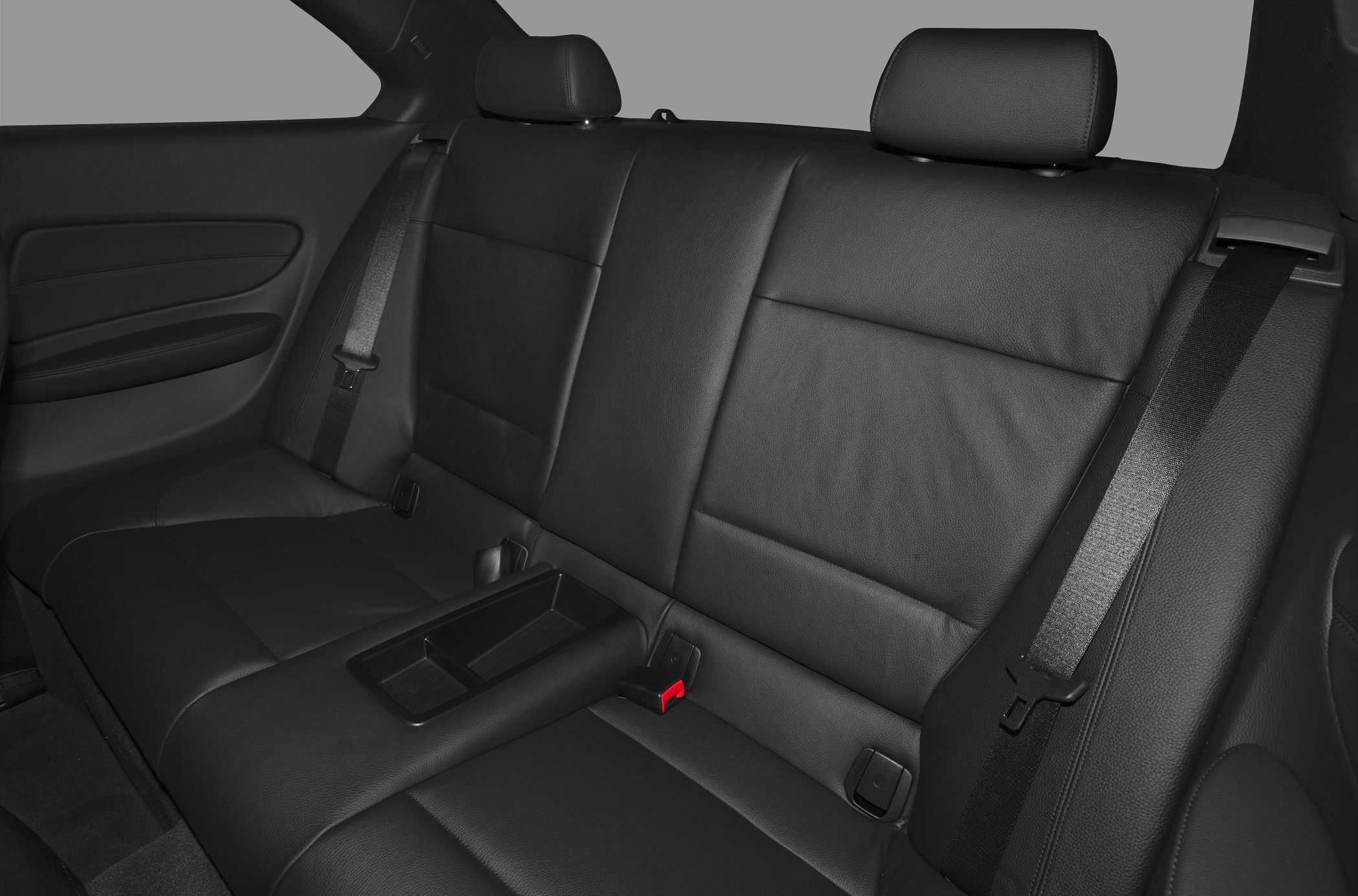 Black leather rear seating with center armrest and seatbelts