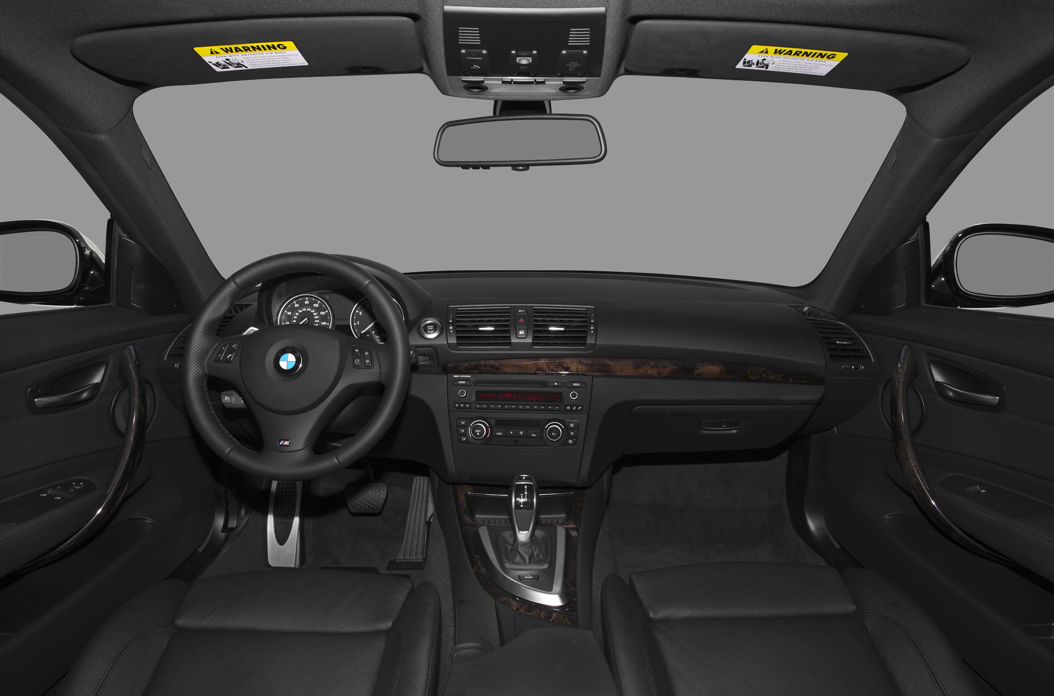 Dashboard, steering wheel, and front seats in luxury coupe interior