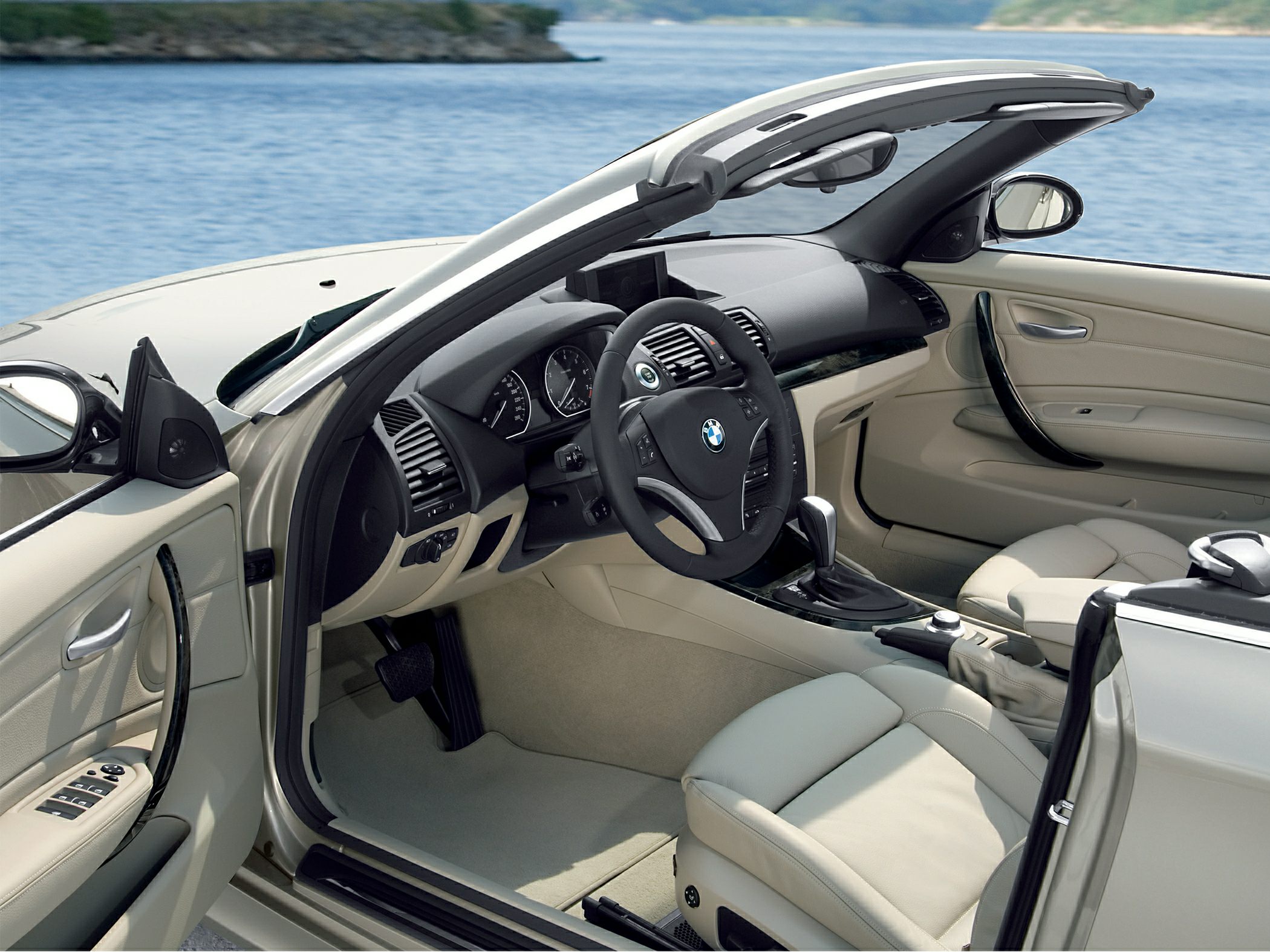 Convertible interior with beige leather seats and modern dashboard.