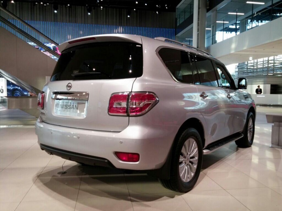 Rear view of a silver large SUV with distinctive taillights and tinted windows