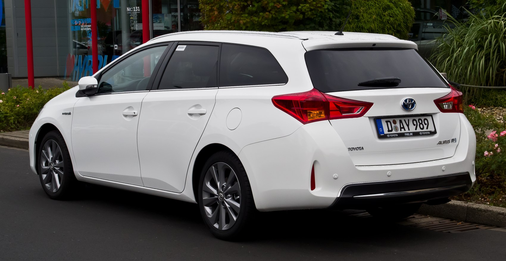 White hatchback rear side with sharp taillights and alloy wheels