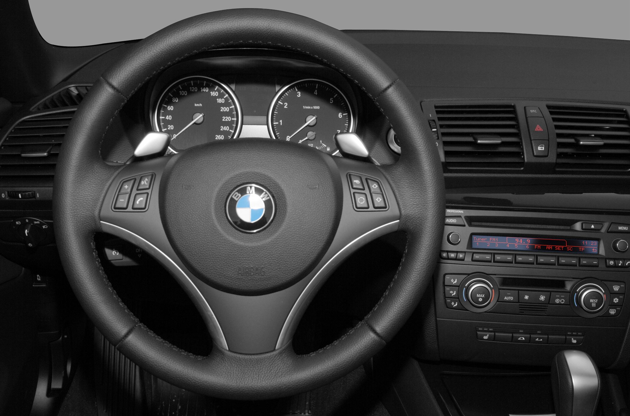 Steering wheel, dashboard with instrument cluster and climate control.