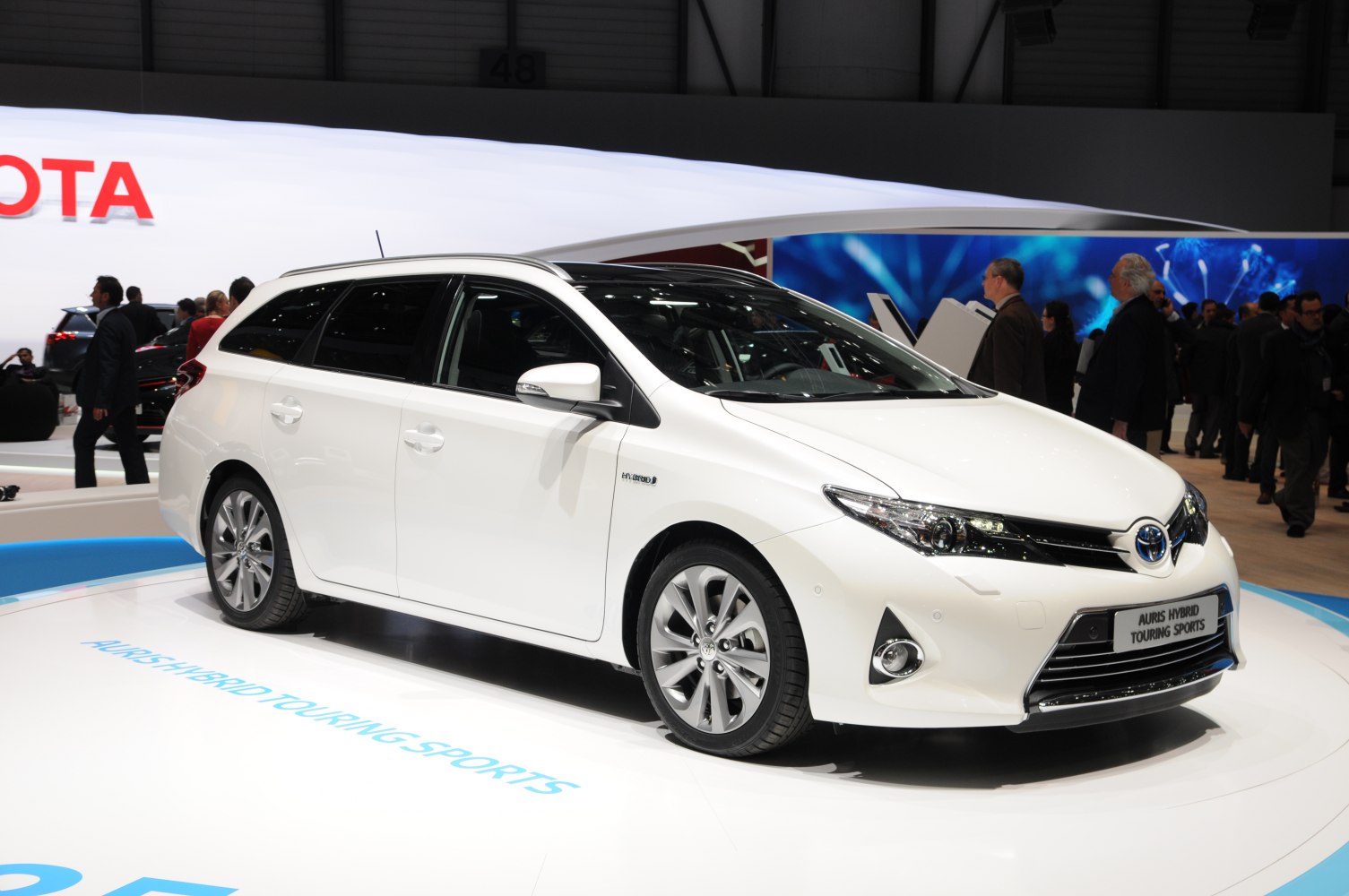 Front side view of hybrid station wagon with sleek headlights and alloy wheels