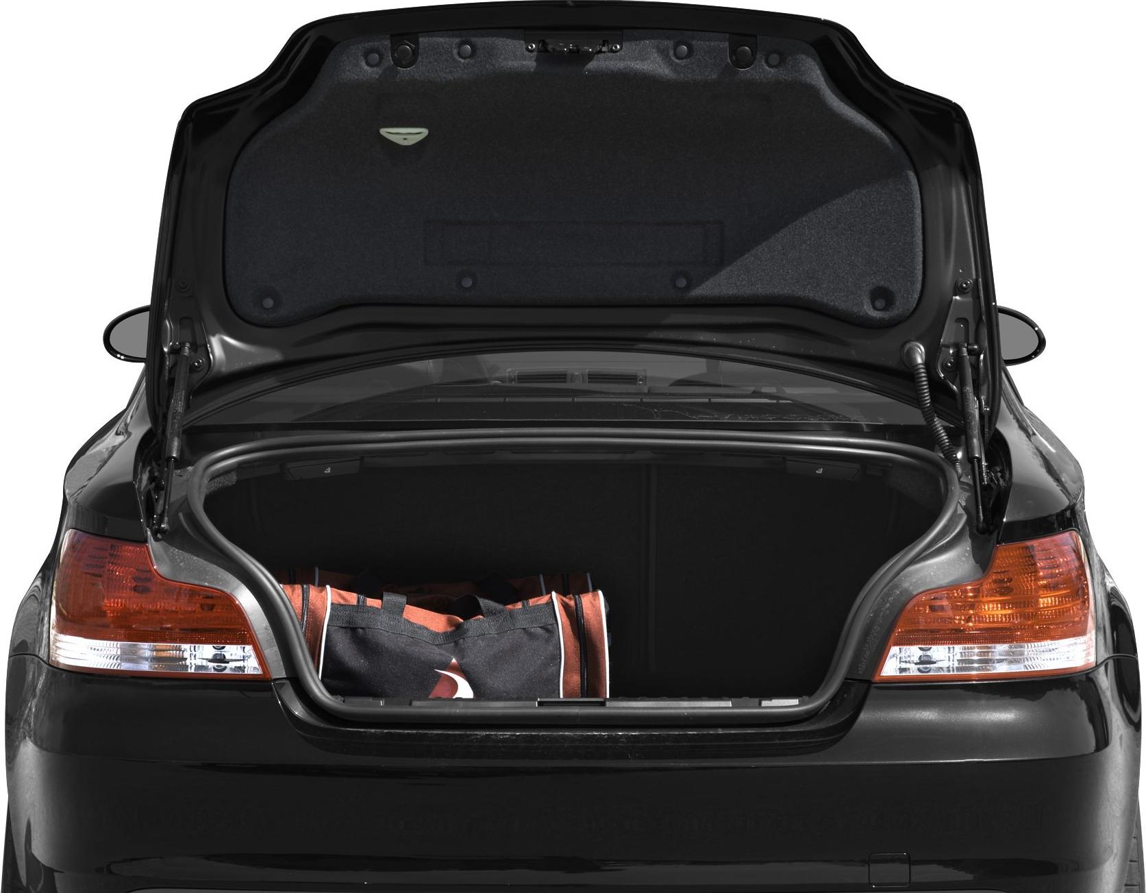 Open car trunk with duffle bag inside, rear taillights visible