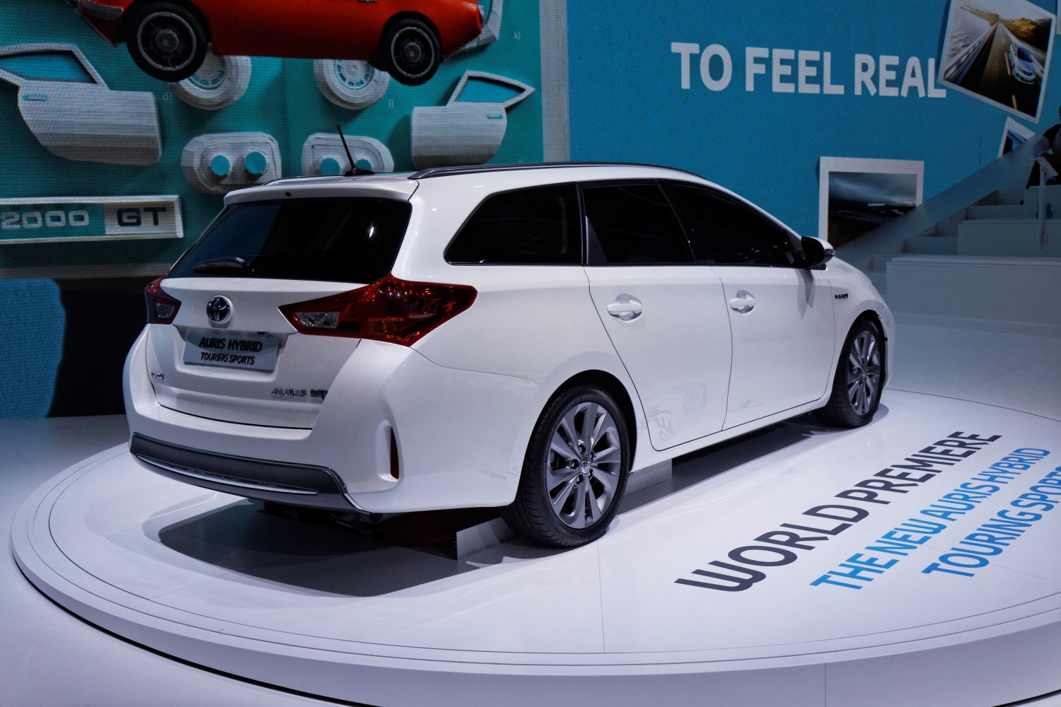 Rear and side view of a white hybrid estate car