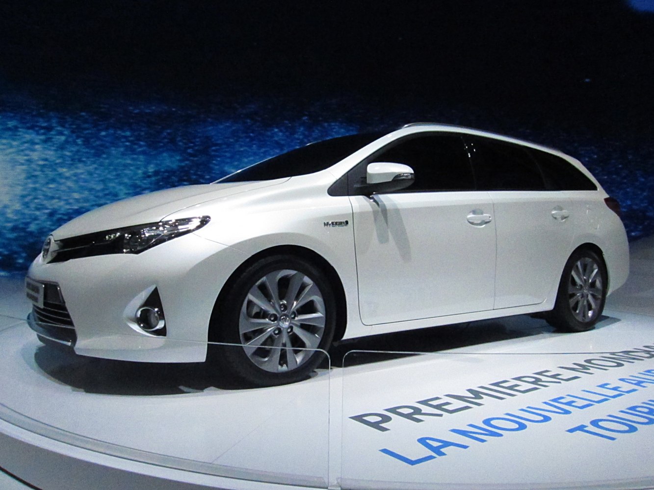 Sleek hybrid touring sports wagon with aerodynamic shape and alloy wheels