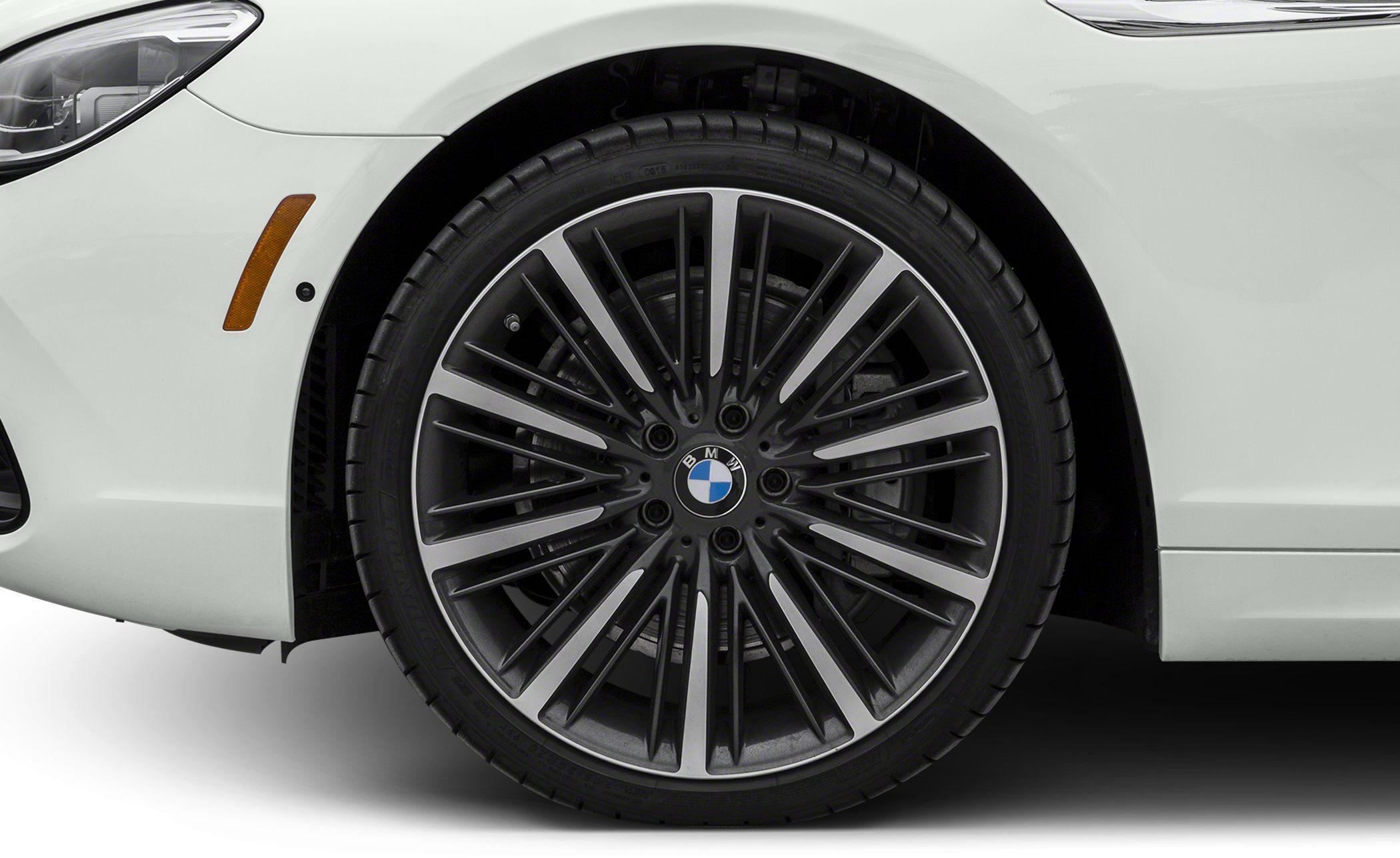 Multi-spoke alloy wheel and tire close-up from luxury sedan.
