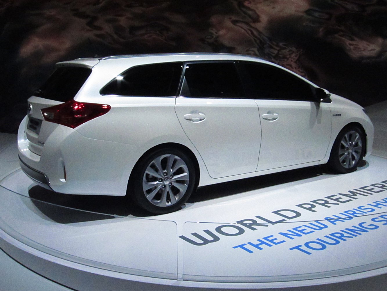 White touring sports wagon with tinted windows and alloy wheels.