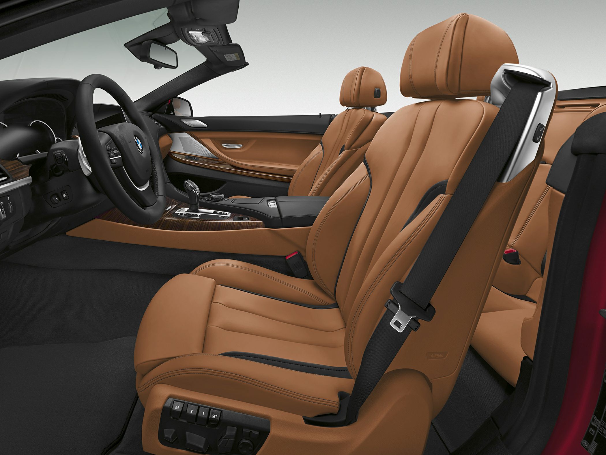 Brown leather seats and advanced seat controls in a convertible interior