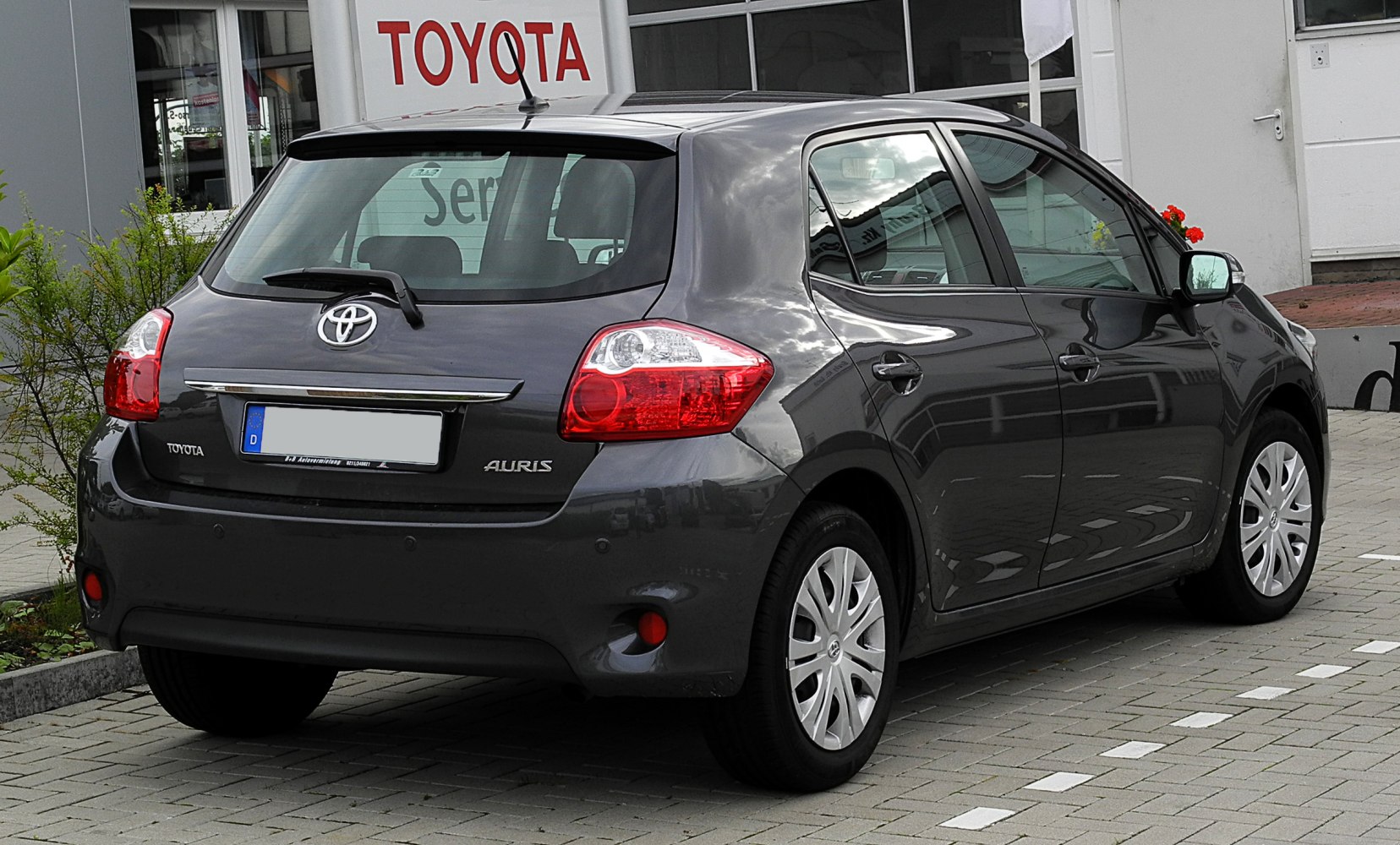 Rear view of compact hatchback with distinct taillights and rear wiper