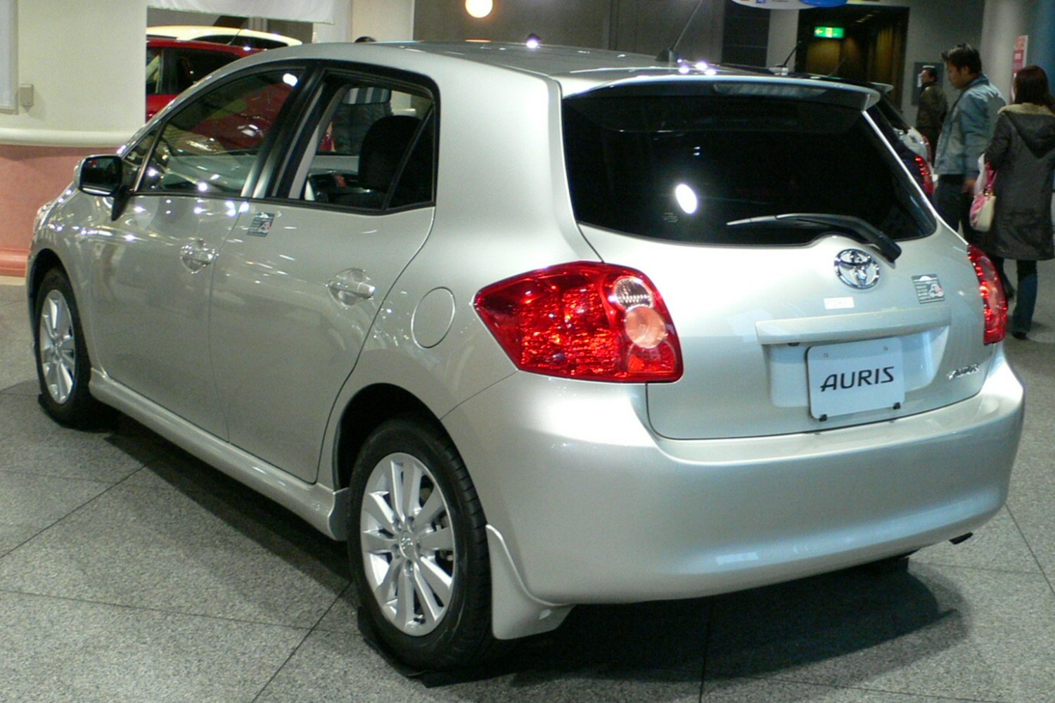 Rear view of silver five-door hatchback with distinct taillights and rear window spoiler