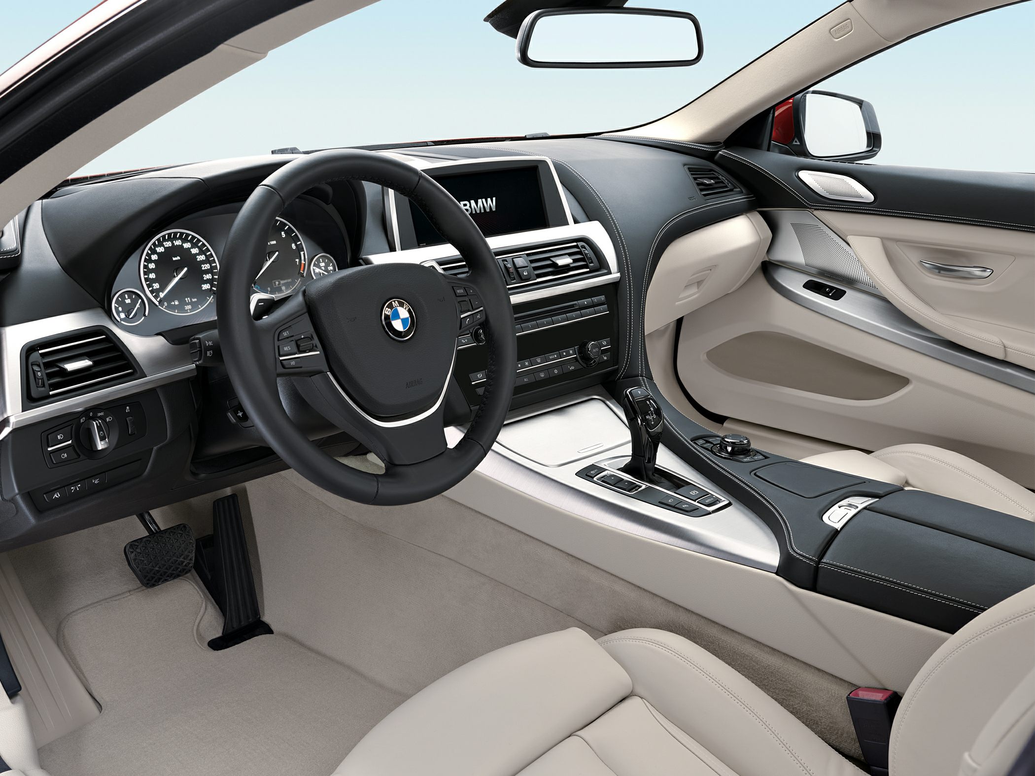 Luxury car interior with dashboard, steering wheel, and gear shifter