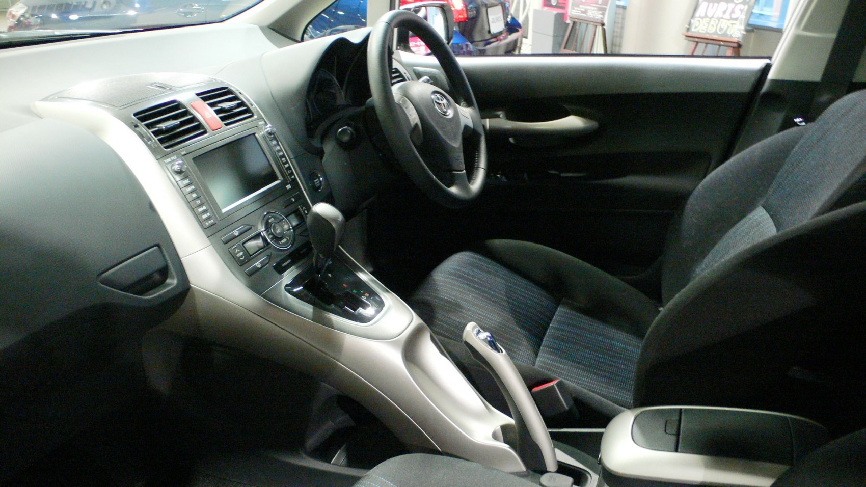Car dashboard and steering wheel with center console controls