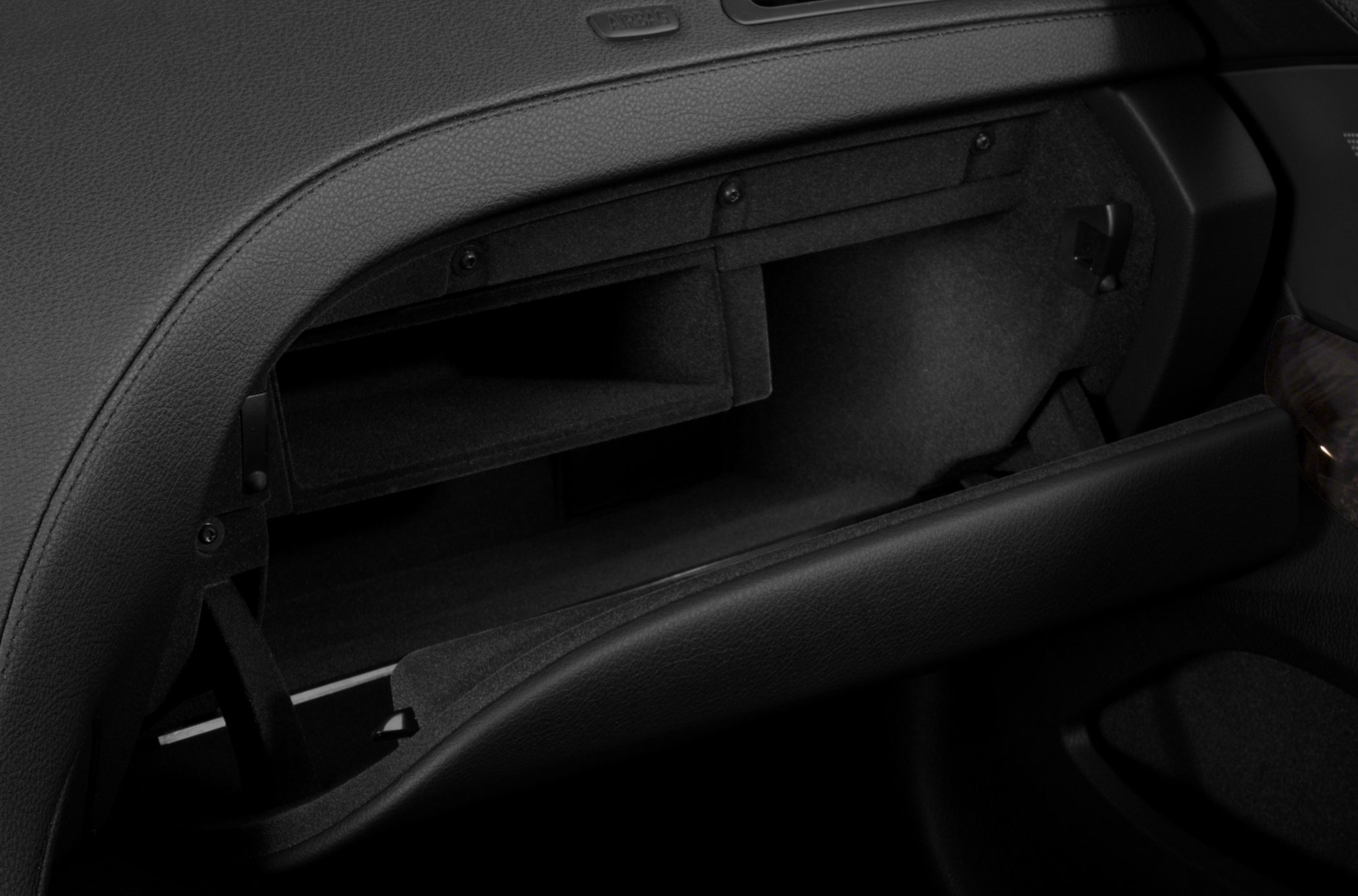 Open glove compartment with leather trim and interior storage space