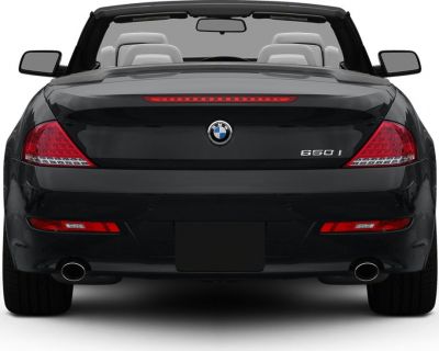 Rear view of convertible with dual exhausts and sleek taillights