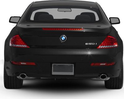 Rear view showing taillights and dual exhaust pipes.