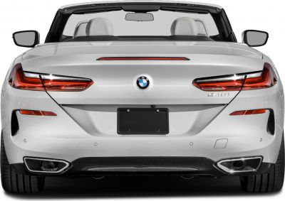 Rear view with sleek taillights, dual exhausts, convertible top down