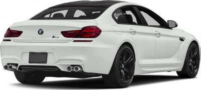 Rear view of a white sporty luxury coupe with quad exhausts and black wheels
