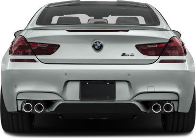 Rear view of a luxury coupe with quad exhaust tips and LED tail lights