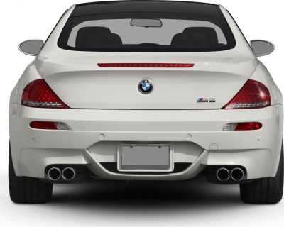 Rear view with quad exhausts and distinctive tail lights