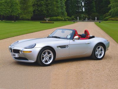 Silver convertible, red seats, chrome side mirrors, sporty roadster design