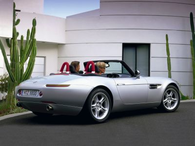 Convertible rear side view with dual red roll bars and silver body