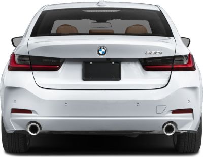 Rear view of white sedan with dual exhaust and modern taillights