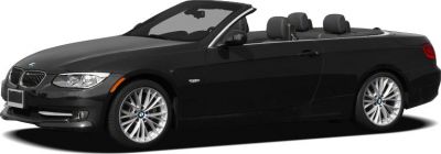 Black convertible with soft top folded down showcasing alloy wheels.