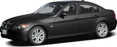 Black sedan front side profile with alloy wheels.