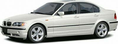 Side profile of a white sedan with alloy wheels.
