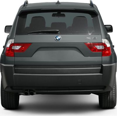 Rear view showing tail lights, rear window, and dual exhaust pipes of SUV.
