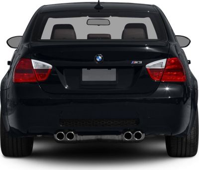 Rear view with quad exhaust and taillights of a black sedan