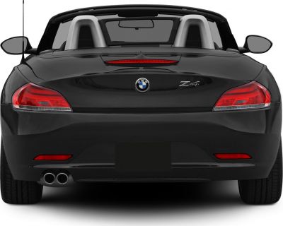 Convertible rear view with tail lights, dual exhausts, and roll bars