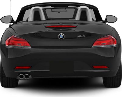 Rear view of a sporty convertible with dual exhaust and prominent tail lights