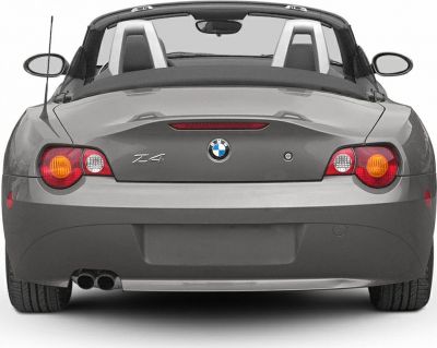 Convertible rear view with taillights, dual exhaust, and roll bars