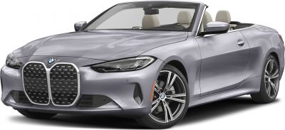 Convertible with large kidney grille and sleek headlights, open roof.