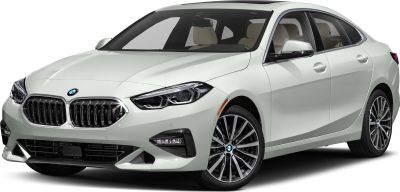 Front view of a luxury compact sedan featuring prominent grille and modern headlamps.