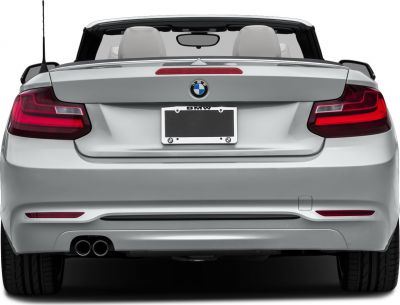 Rear view with tail lights and dual exhaust of convertible with open roof