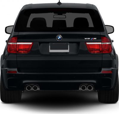 Rear view of SUV with quad exhausts and taillights.