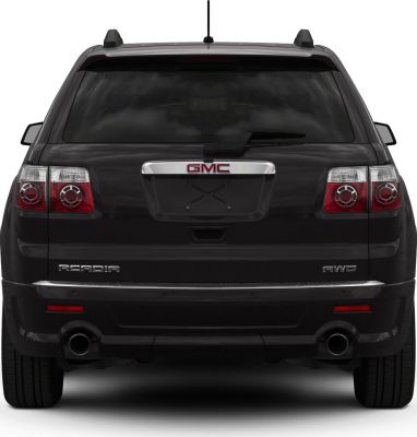 Rear view of black SUV with dual exhaust and tail lights.