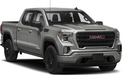 Front side view of a gray pickup with aggressive grille and black wheels
