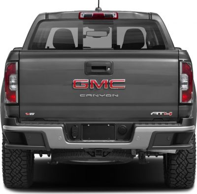 Rear view of pickup tailgate with V6 and AT4 badges