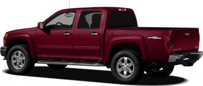 Side view of mid-2000s off-road crew cab pickup with chrome wheels