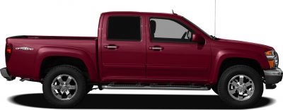 Side view of a crew cab pickup with off-road tires and chrome rims